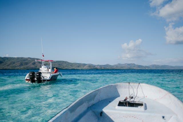 Boats on clear Caribbean waters with scenic islands in the background 